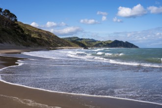 Castlepoint Beach, ocean, sandy beach, surf, mountains. Castlepoint, Wairarapa Coast, Wellington
