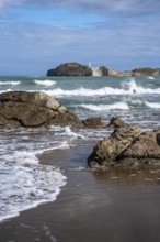 Castlepoint Beach and Castlepoint Lighthouse, ocean, waves, surf, sandy beach, rocks. Castlepoint,