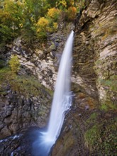 Diesbach waterfall in autumn-colored surroundings, Linthal, Klausenpass, Canton of Glarus,