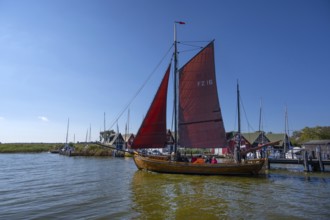 Zeesboot, former historic fishing boat, leaves the port of Ahrenshoop, blue sky, Darß,