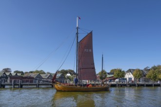 Zeesboot, former historic fishing boat in the port of Ahrenshoop, blue sky, Darß,