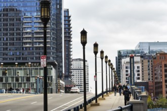 Street lights on Congress Street Bridge, passers-by on pedestrian walkway, office towers, Financial