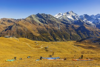 Paragliders prepare their start, summit of the Corne de Sorebois, with the backdrop of the Valais