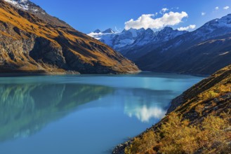 The Lac de Moiry reservoir, with the snow-capped peaks of the Grand Cornier, Tete Blanche and