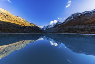 The Moiry glacier and mountain peaks are reflected in Lac de Chateaupre, Val d'Anniviers, Valais