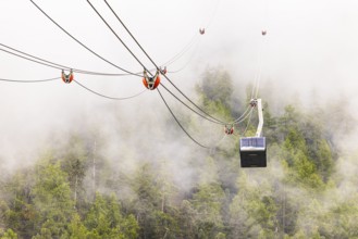 Gondola and cable car line in fog, cable car from Grimentz to the Espace Weisshorn summit station,