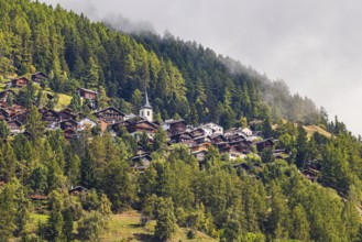 Rising fog over the mountain village of Saint-Luc, Val d'Anniviers, Valais Alps, Canton of Valais,