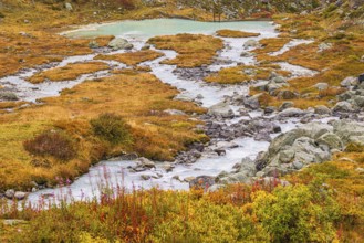 A glacier stream flows from Lac de Chateaupre into the Lac de Moiry reservoir, Val d'Anniviers,