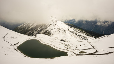 Another onset of winter in May, Riezler Alpsee, an artificially created lake, snow pond, feeds the