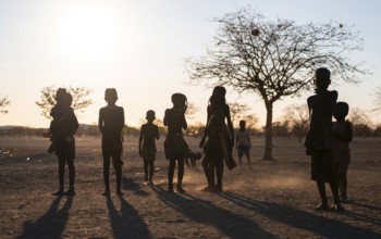 Himba children playing, evening mood, traditional Himba village, Kaokoveld, Kunene, Namibia