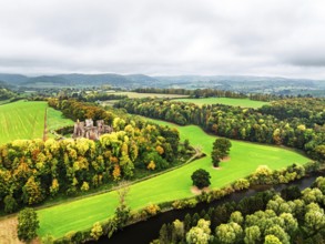 Autumn Colours over ruins of Goodrich Castle and River Wye from a drone, Goodrich, Herefordshire,