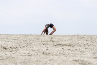 Abstract, woman doing gymnastics in a whirring landscape, Etosha pan, Etosha National Park, Namibia