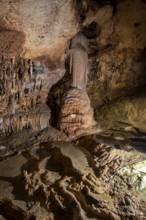 Stalactites and stalagmites, rock formations in a stalactite cave with water basin, Grotta del