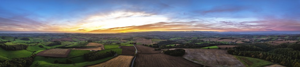 Sunset of Devon Farms and Fields over Berry Pomeroy from a drone, Totnes, England, United Kingdom