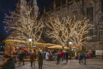 Famous Nuremberg bratwurst house decorated at Christmas time, Sebaldus Church in the back,