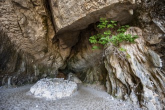 Stone men in a rock cave on the beach at Cala Luna, Golfo di Orosei, Baunei, Sardinia, Italy