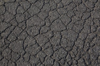 Top view and close-up of cracked asphalt road surface, Quebec, Canada