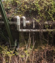 District heating pipeline in front of old industrial buildings on the banks of the Wupper,