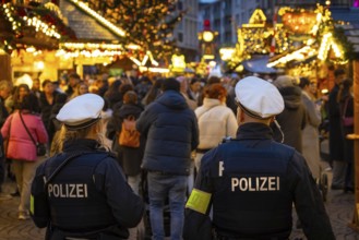 Two policemen patrol the Frankfurt Christmas market, Römerberg, Frankfurt am Main, Hesse, Germany