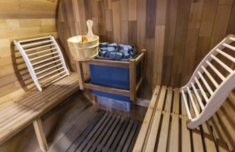 Steam and hot stone wooden cedar compact sauna interior with heating stone electrical device, hot