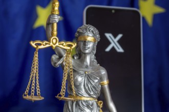 Symbolic picture of the EU Commission's fine against X: Justice, smartphone with logo of X and EU