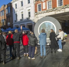 People on the Cornhill in the town centre view the first ever UK Portal in Ipswich, Suffolk,