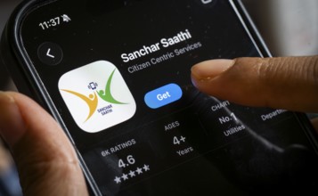 In this photo illustration, a person downloads the Sanchar Saathi mobile application on an iPhone,