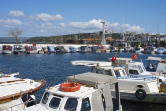 A busy harbor full of boats with flying flags under blue skies, Çanakkale, Canakkale, Marmara