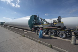 Overlong heavy-duty transporter with a part of a wind turbine, at a motorway rest area of the A9,