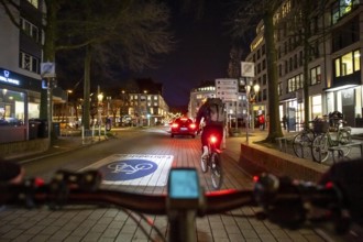 Cycling in the city, in the dark, in the evening, inner-city road, bicycle road, two-wheeler