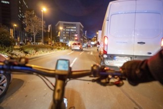 Cycling in the city, in the dark, in the evening, cycling on a bike lane, Huyssenallee, downtown