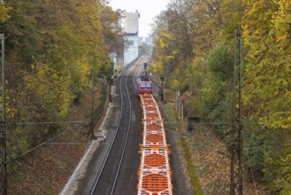 Freight train traveling on open route. Münster CHP plant. Stuttgart, Baden-Württemberg, Germany