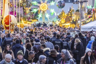 Busy shopping street in Stuttgart. Police patrol in the midst of the crowds. On the first weekend