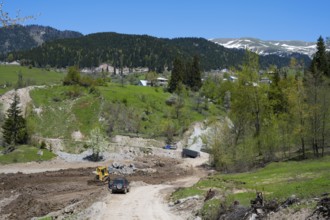 A construction site on a dirt road in a hilly forest landscape, on the way to the Goderdzi Pass,