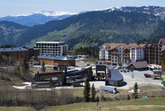 A modern resort in the mountains with a breathtaking view of the surrounding hills, ski resort,