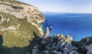 Picturesque rocky coast, cliffs with L'Aguglia pinnacle, blue sea and Cala Goloritzé beach, aerial