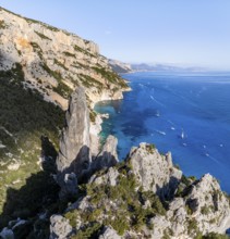 Picturesque rocky coast, cliffs with L'Aguglia pinnacle, blue sea and Cala Goloritzé beach, aerial