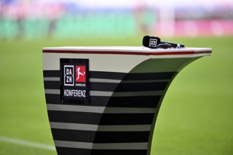 Microphone is on presentation table, DAZN, logo Bundesliga conference, conference call, Allianz