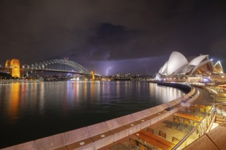The Sydney Opera and Bridge in the dark and approaching thunderstorm, spectacular lightning over