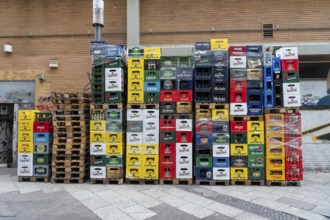Empty beverage crates, from various manufacturers, bottling, types, stacked at a restaurant, for
