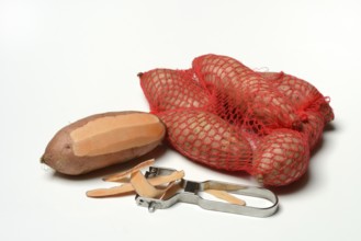 Sweet potato with potato peeler, Ipomoea batatas