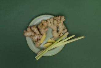 Ginger tubers and lemongrass on plate, Zingiber officinale, Cymbopogon citratus