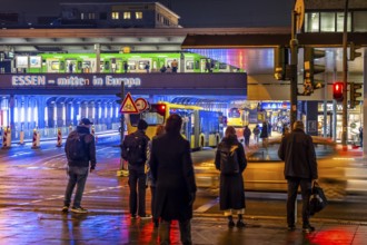 The main train station in Essen, blue illuminated underpass, bus station, am Europaplatz, train on