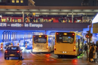 The main train station in Essen, blue illuminated underpass, bus station, am Europaplatz, train on