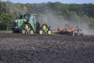 Crawler tractors harrow the field, Othenstorf, Mecklenburg-Western Pomerania, Germany