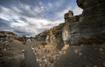 Eroded rock formations, volcanic landscape with dramatic cloudy skies, Ciudad Estratificada or Los