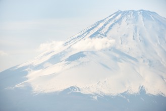 Snow-covered summit of Mount Fuji volcano in spring, Owakudani, Hakone, Japan