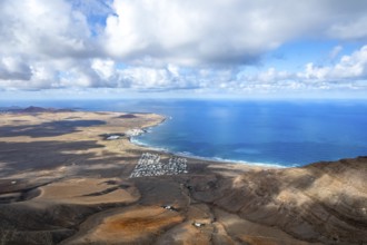 View from the Risco de Famara cliffs to the coast and the sea with the Famara beach, Playa de