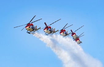Indian Air Force (IAF) ALH Mk1 Sarang helicopters soar through the sky during an air show as part