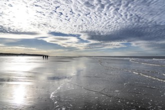 Walkers on the Wadden Sea near the East Frisian island of Spiekeroog, west of the North Sea island,